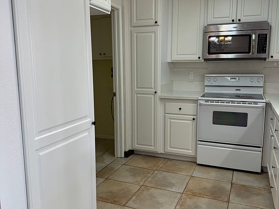 Kitchen leading to laundry room on left