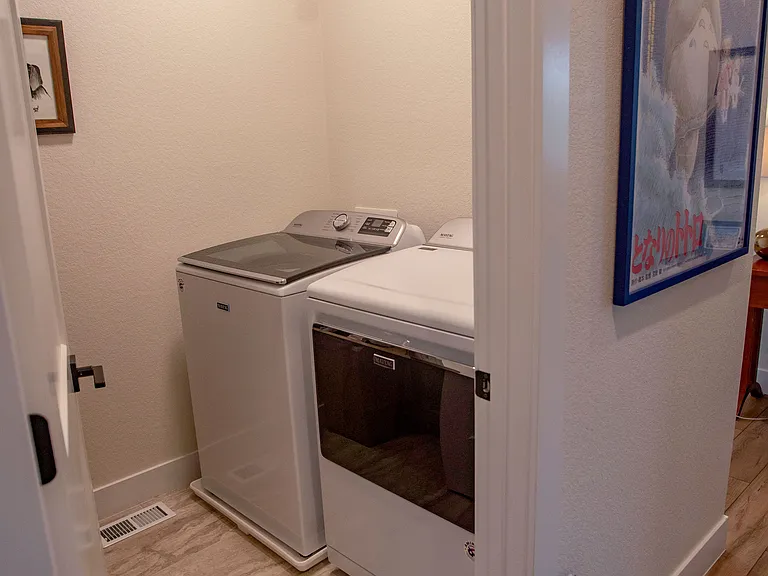 Washer and dryer (new, maytag). Also has large utility sink on other side. Upstairs.