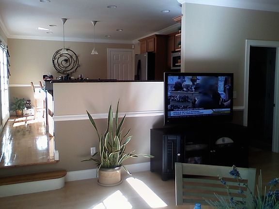 View of the family room with custom crown molding and open to the kitchen