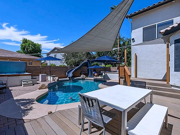 A fun and refreshing backyard pool, slide and BBQ!