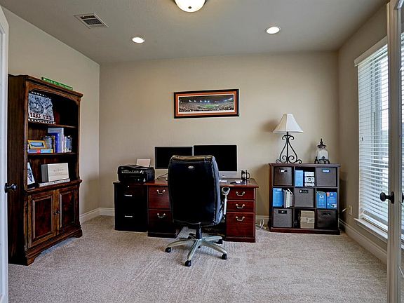 At the right of the entry is the study with French glass doors