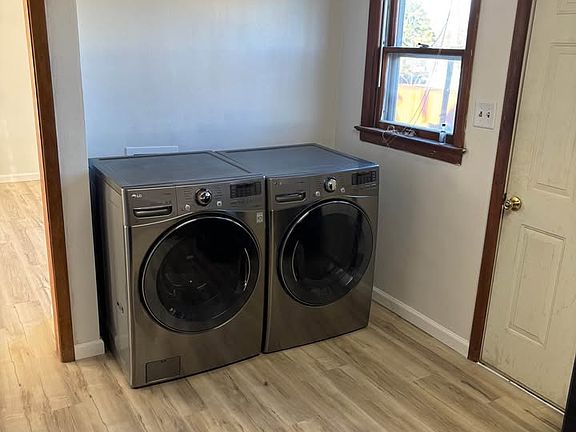 View inside kitchen with washer and dryer and back door to the right.