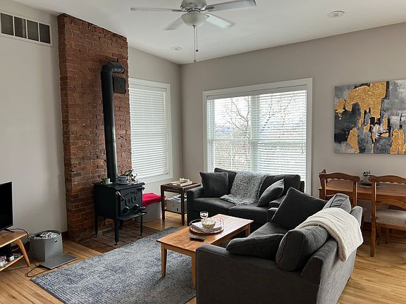 Great room with a high sloping ceiling and tons of natural light.
