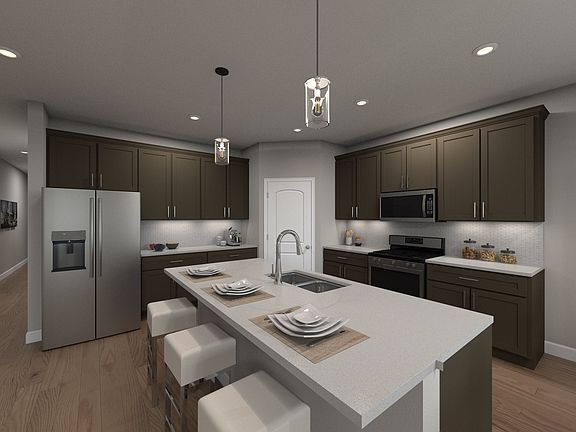 An island, walk-in pantry, and plenty of cabinet space offer easy solutions for meal prep.