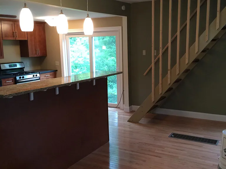 kitchen, slider to deck and stairs to upstairs.