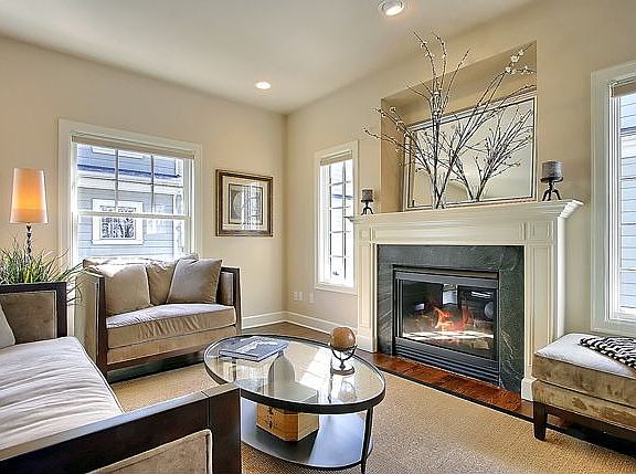 Light-filled living room with gas fireplace.