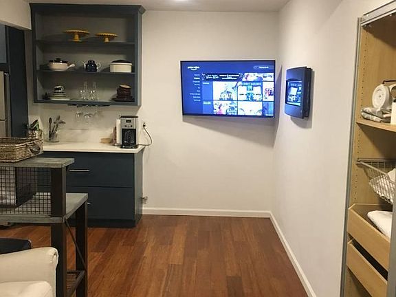 Living room area has bamboo floors + electric fireplace + TV