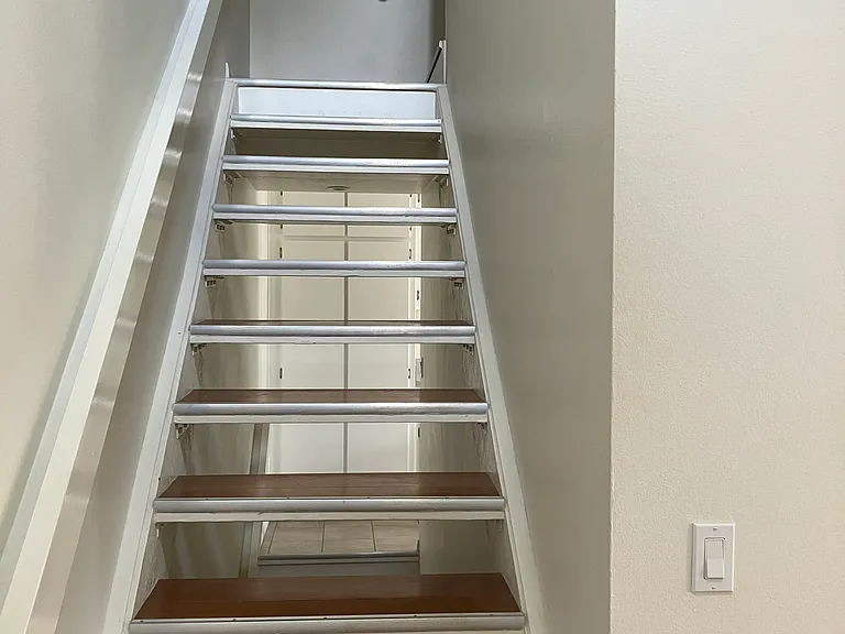 Stairs to upstairs bedrooms and directly below down to the 2 car garage.