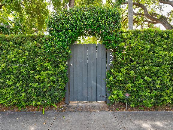 Lushly landcaped Gated arched arbor pedestrian entry