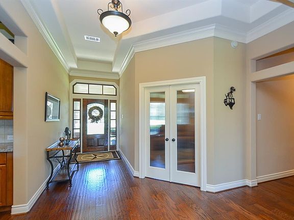 The Foyer is a perfect example of architectural beauty and sophistication.  The combination of the raised ceiling with triple crown molding complement the beautiful wood floors and create a space that is truly stylish.