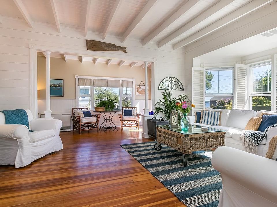 Sunny, breezy and open living room and adjacent sun room feature views of the Portland shipping channel from all the windows. Plenty of space for everyone and a cozy gas fireplace for cool Maine evenings.