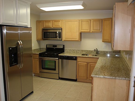 New maple cabinets, SS appliances, Brazilian granite counter, and tile floors.