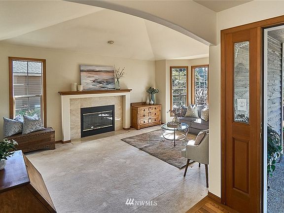 Living room features fireplace and vaulted ceiling