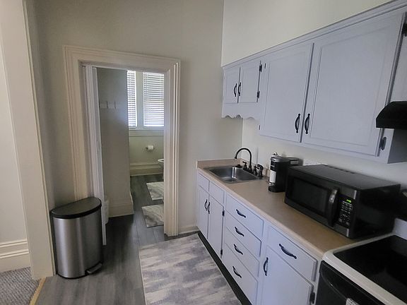 Kitchen looking into Bathroom