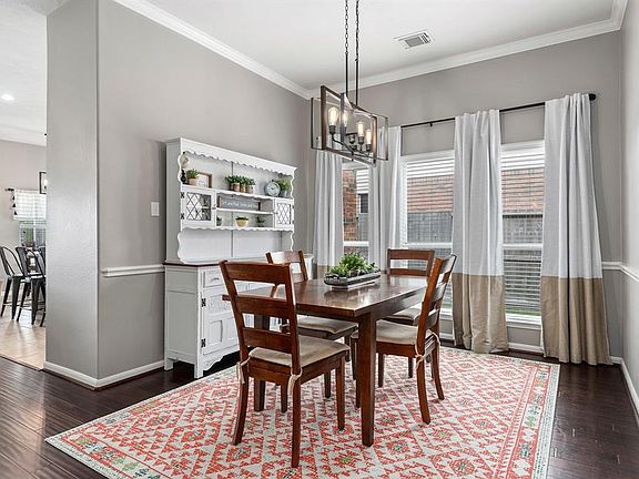 The dining room is the perfect place for entertaining. It opens up into the main living area and quick access to the kitchen.