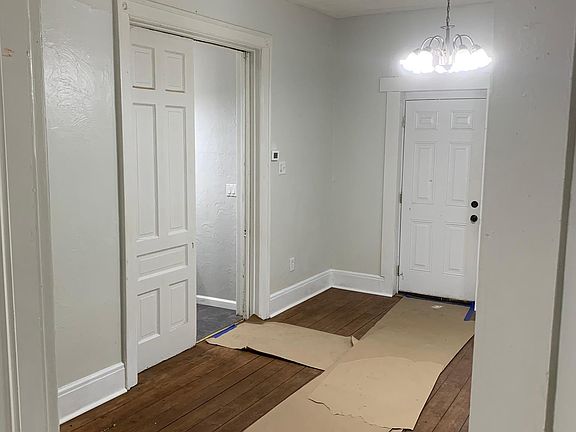 Living room, showing front door (right door) and bathroom entrance (left door)