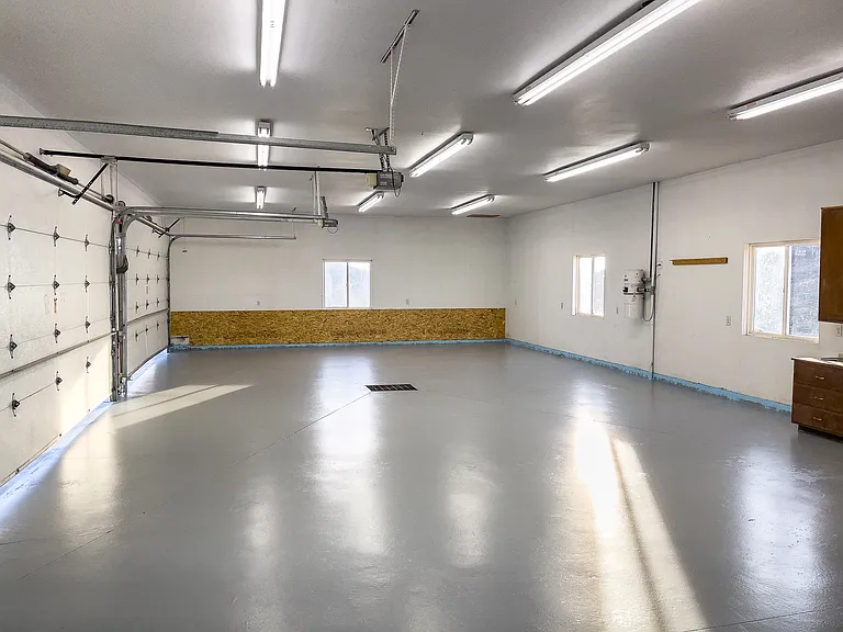 oversized four car garage that provides space for cars and hobbies.