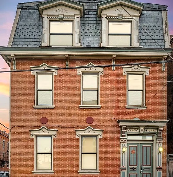 Front of the building on Bingham Street. 3rd floor with two large double hung windows one in each bedroom.