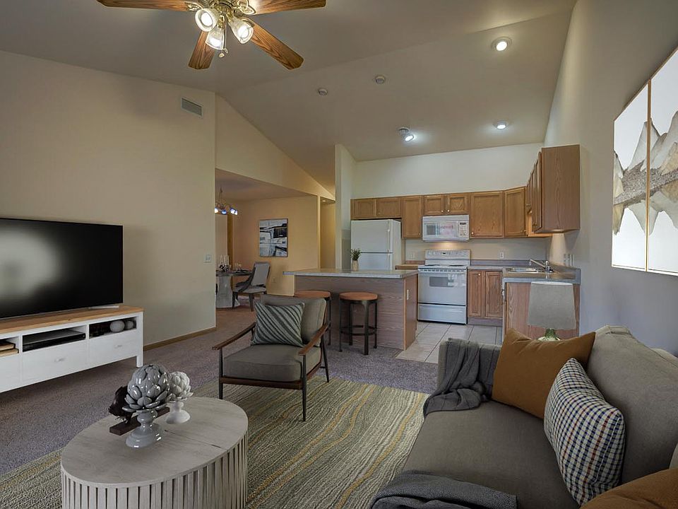 Similar unit; virtually staged. Living room/kitchen/dining room. Available unit does not have vaulted ceilings