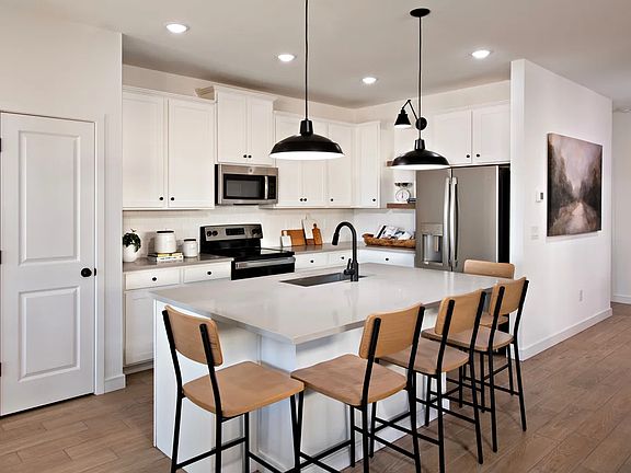 Kitchen with pendant lighting and floating shelves