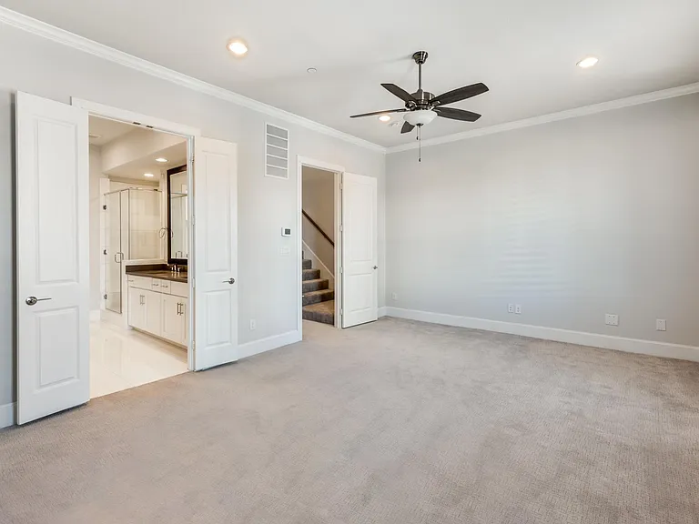 The primary bedroom suite provides ample space for a king-sized bed, dresser, seating area and more!