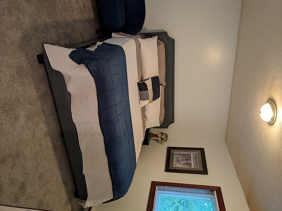 King size bed on a platform base with a padded headboard/footboard and extra thick quality mattress.