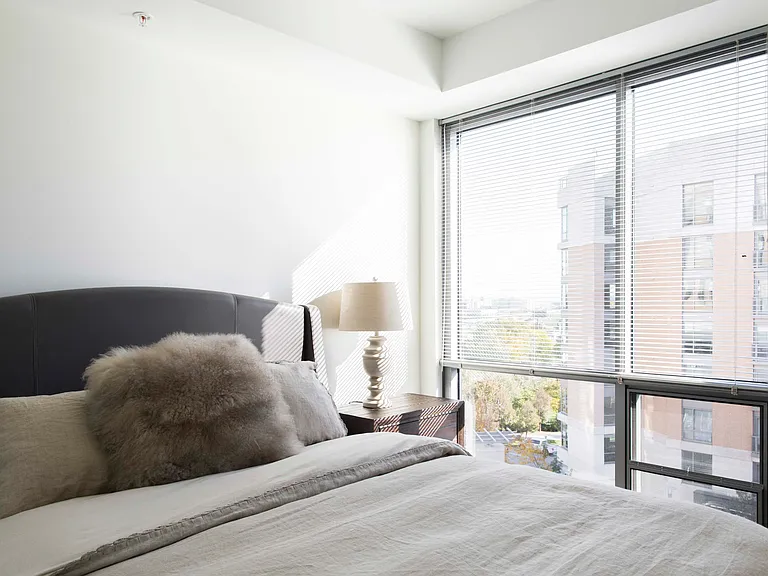Wake up to stunning city views from your cozy and stylish bedroom retreat.