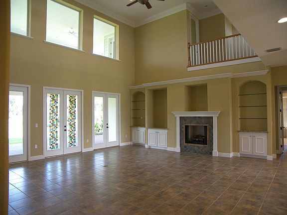Incredible two story great room with gas fireplace and custom built in shelves