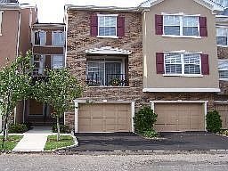 Garage is in the Center with Balcony and windows above and to the right