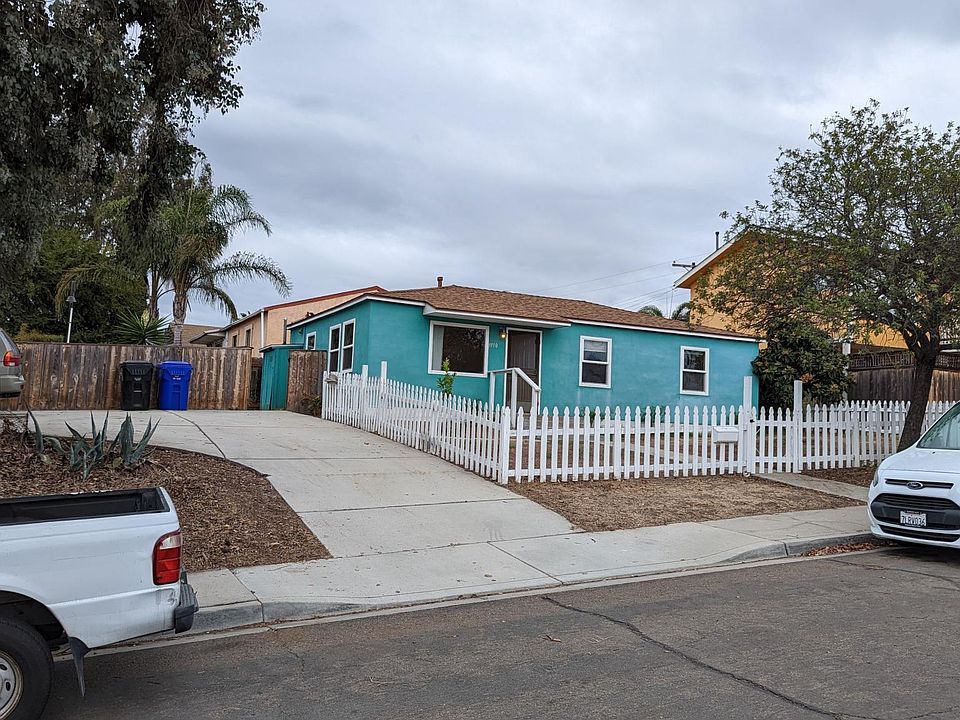 Detached house with large private yard and picket fence.