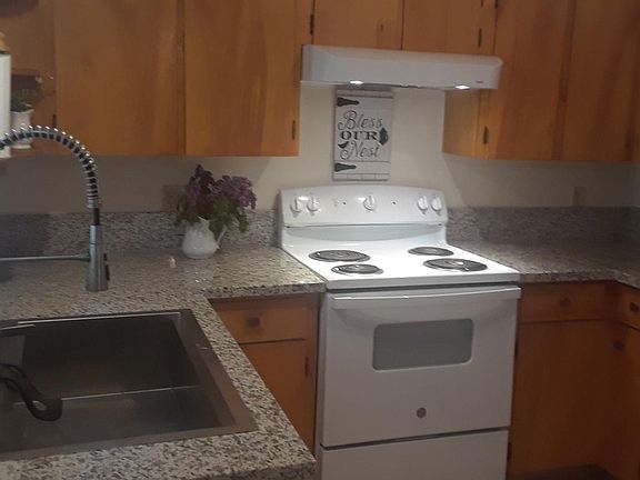 Updated kitchen new granite counters, sink stove and blinds