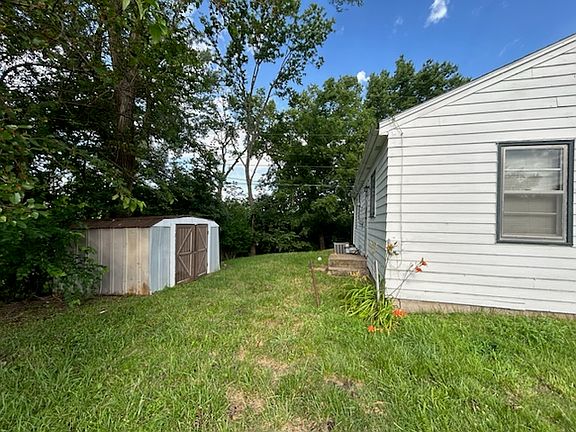 Back of house with storage shed
