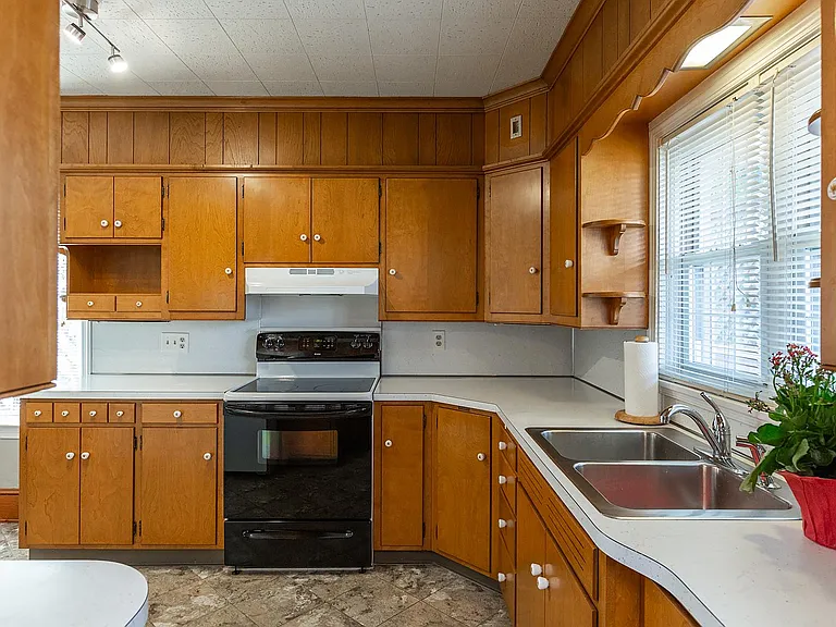Kitchen with new appliances and solid wood cabinets.