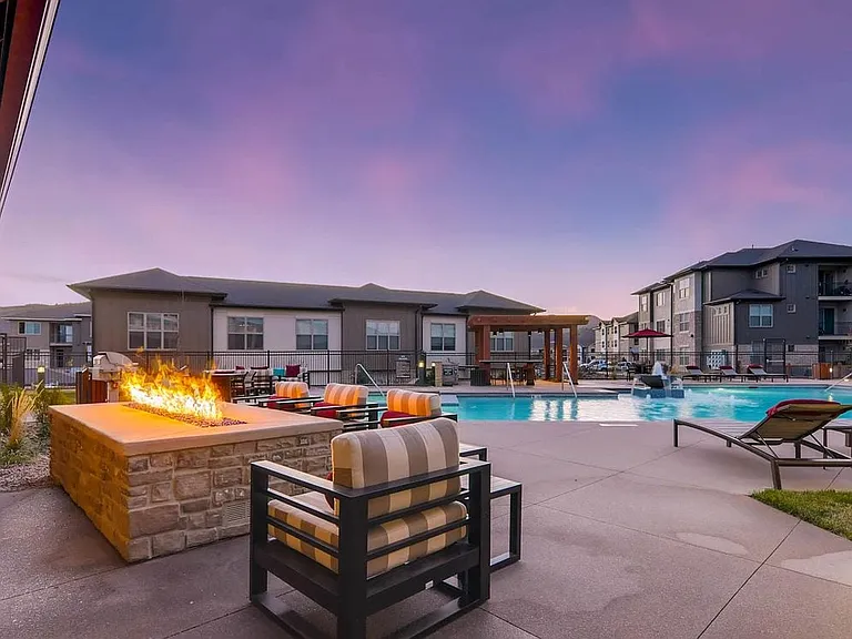 Outdoor courtyard with swimming pool, sundeck with lounge seating and fireplace