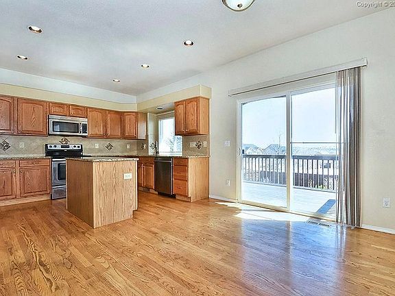Large kitchen, eat in dining room, wood flooring, slab granite, stainless applia