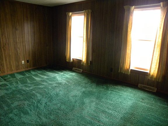 Den. Paneling has been painted off white.