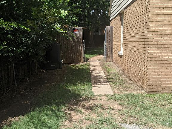 Parking space and walkway to front gate.