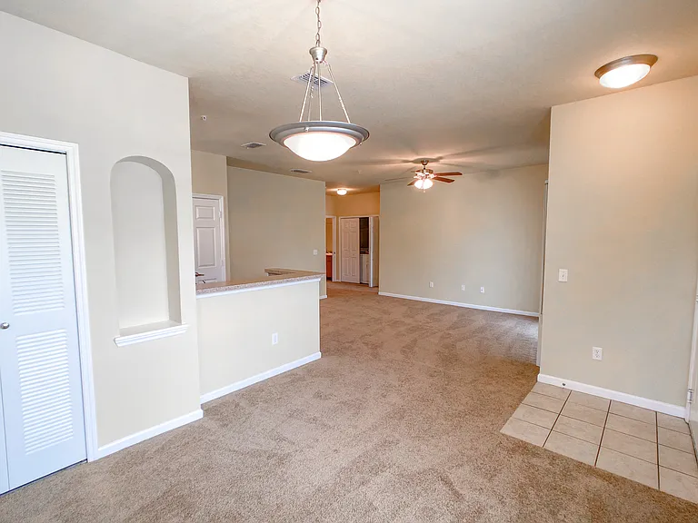 Open Concept Design with Lush Carpets in Living and Dining Room Open Concept Design with Lush Carpets in Living and Dining Room