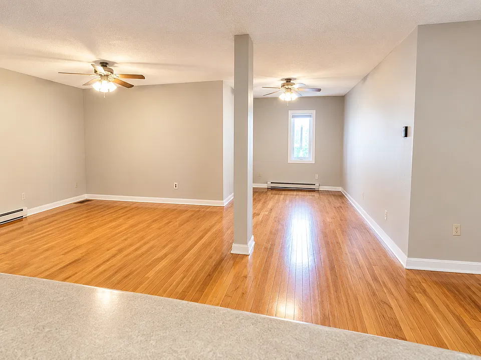 Enjoy an open-concept living area featuring beautiful floors, neutral finishes, and plenty of room to create your perfect hangout spot.