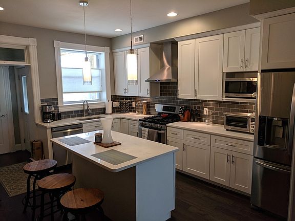 Kitchen looking towards the back of the house. Door to the parking pad is back right and door to half bath is straight back.