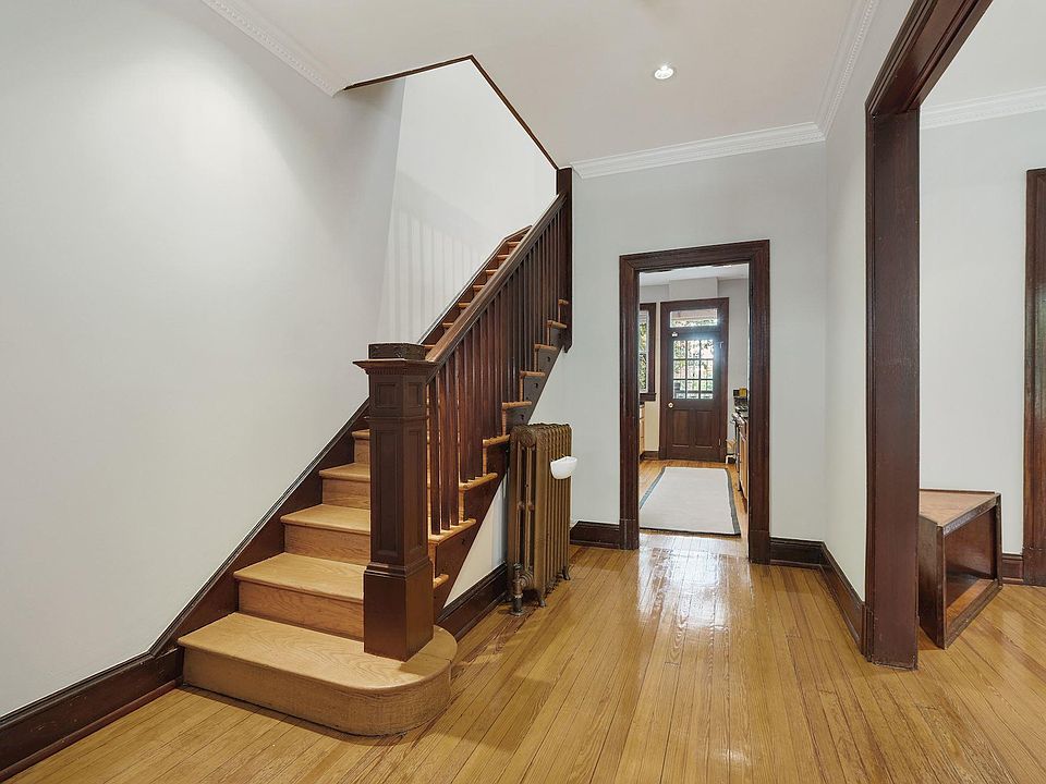 Original restored woodwork and trim. Bronze radiators with turn of the century engraving. Grand foyer.