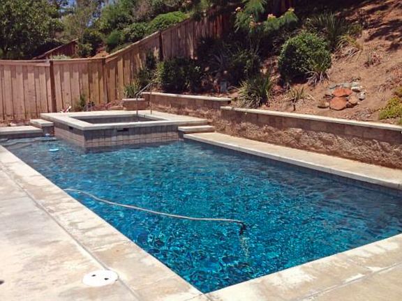 Fenced in large backyard with pool and spa