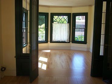 View from dining room, through the leaded glass trifold doors, to living room.