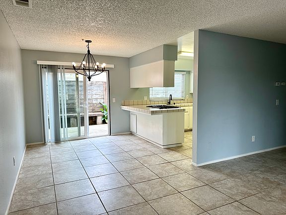 Easy to clean tile floors and counter tops!! Sliding glass door going out to enjoy your morning coffee on your own private patio!!