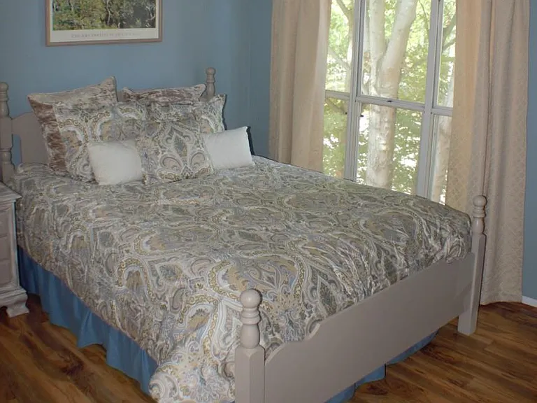 Primary Bedroom with Queen Bed, dresser and ceiling fan