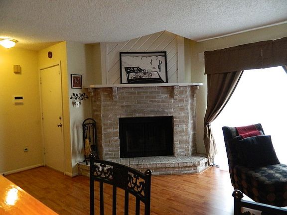 This inviting living area radiates hospitality and charm with it's floor to ceiling wood burning fireplace.