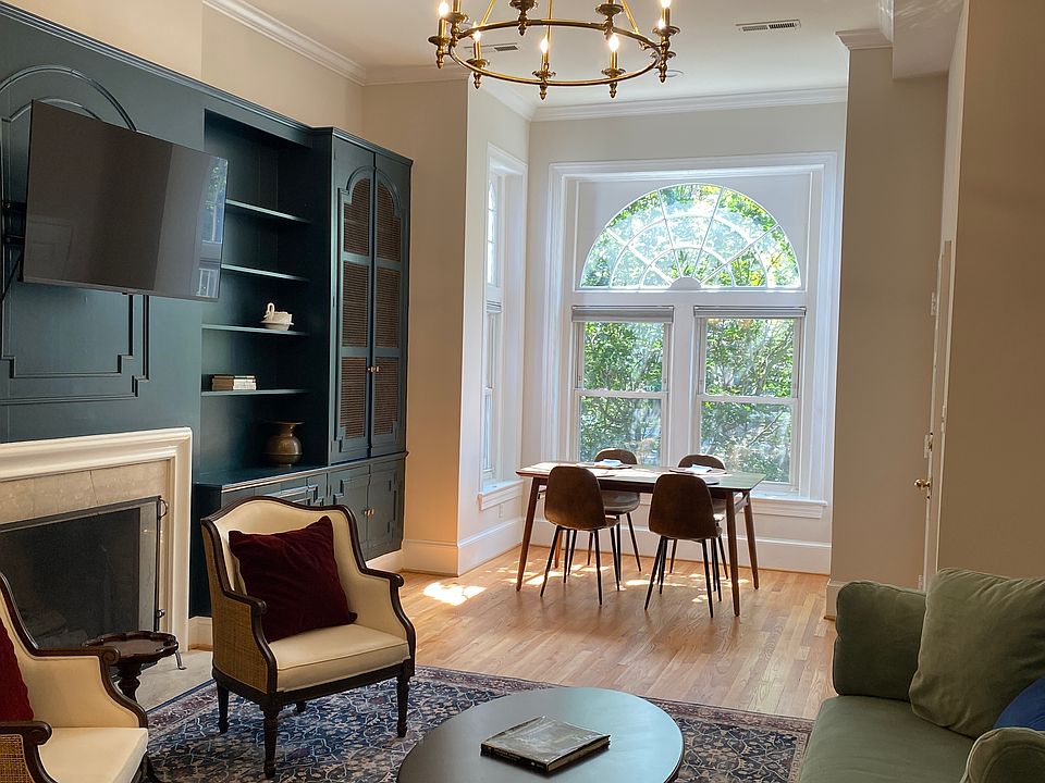 Open sitting and dining area with large windows looking out on trees