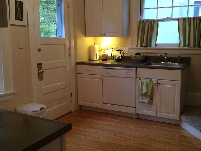 Kitchen with dishwasher, microwave. Exterior door leads to