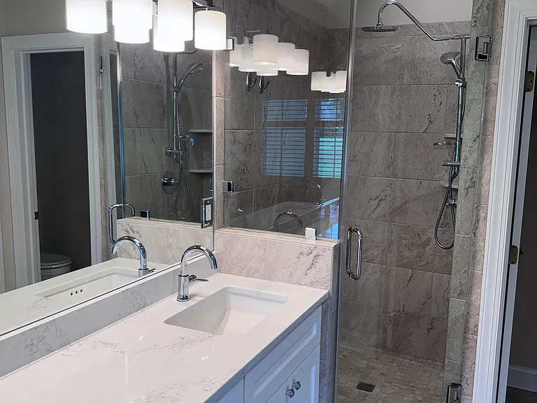 Primary bath features large Rain Shower and handheld option.