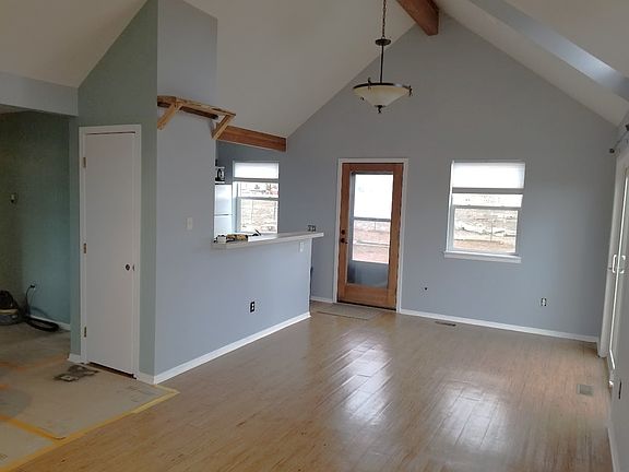 Living area adjacent to kitchen with door leading to back yard.